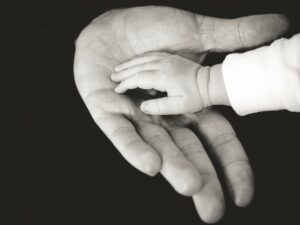 baby hand in an adults hand.